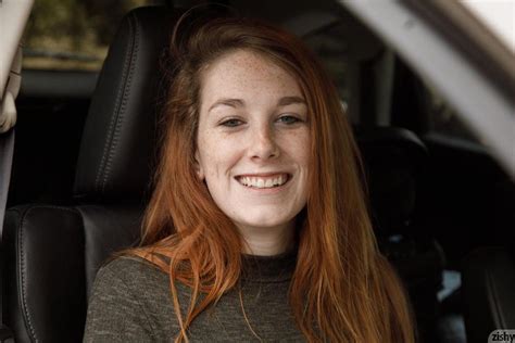 Smiling Redhead With Freckles In A Car