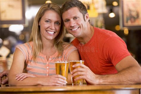 Happy Young Couple Having Beers At A Bar Stock Image Image Of