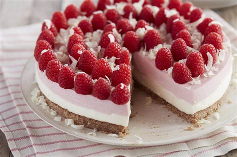 Cheesecake squares, lightened up with yogurt and light cream cheese, baked on a chocolate graham cracker crust drizzled with melted chocolate. No Bake Gluten-Free White Chocolate Raspberry Cheesecake