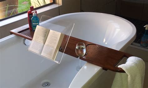 It features removable wine glass holders, a tablet or book holder, and plenty of space to keep other bath necessities, too. Bath caddy with book and wine glass holder made from brown ...