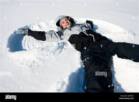 Man Making Snow Angel Stock Photo Alamy