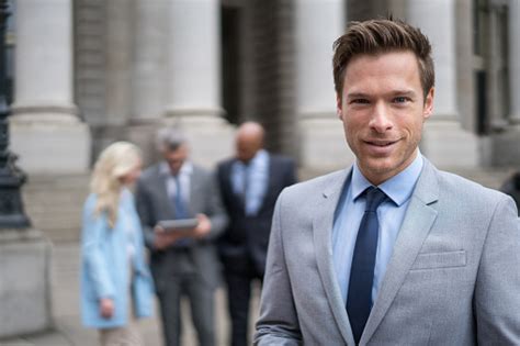 Successful Business Man Leading A Group Stock Photo Download Image