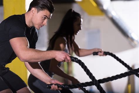 Premium Photo Young Fit Sports Couple Working Out In Functional