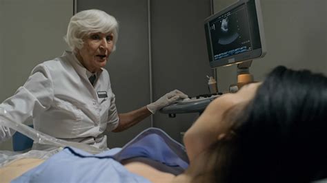 senior female doctor performing ultrasound stock footage sbv 326775817 storyblocks