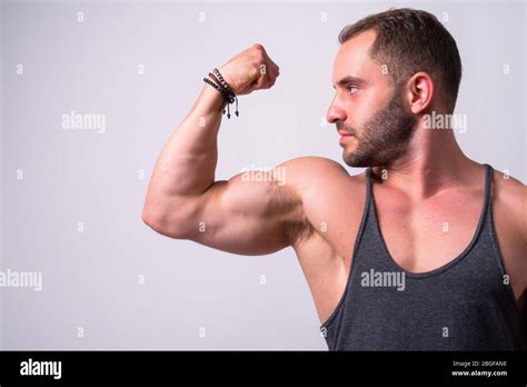 Portrait Of Muscular Bearded Man Flexing Bicep Stock Photo Alamy