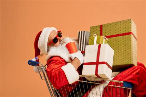Santa Claus Inside Shopping Cart With Lots Of T Boxes Stock Photo