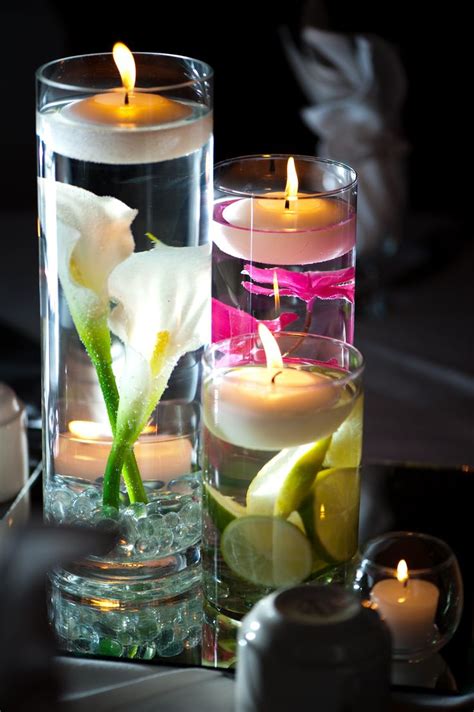 Glass Vases Filled With Submerged Calla Lilies And Other Bright Flowers