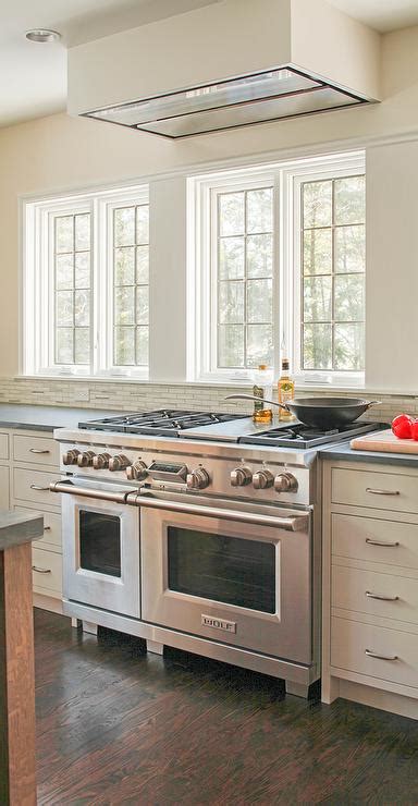 You'll have more say over the final product than you would with stock cabinets. Windows Above Stove - Transitional - Kitchen