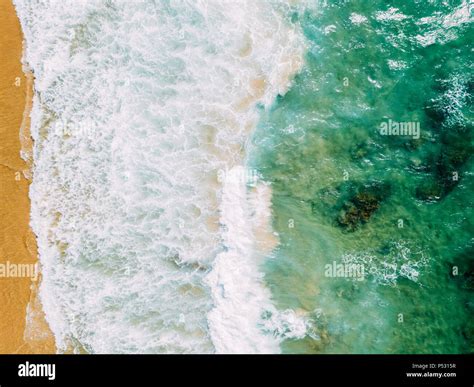 Aerial Panoramic Drone View Of Blue Ocean Waves Crushing On Sandy Beach