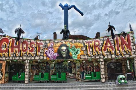 An Amusement Park With Lots Of Colorful Graffiti On The Front And Side