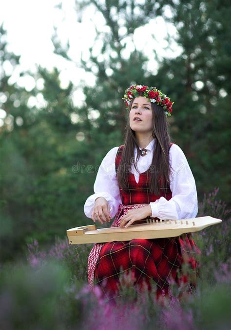 Beautiful Young Woman Playing Celtic Harp And Singing Song In Woodland