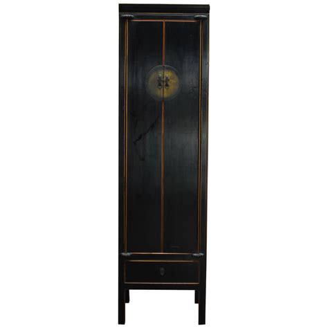 This slim cabinet has no fixed center shelf, making it ideal for storing brooms and other tall items. Chinese Tall Black Lacquer Cabinet For Sale at 1stdibs
