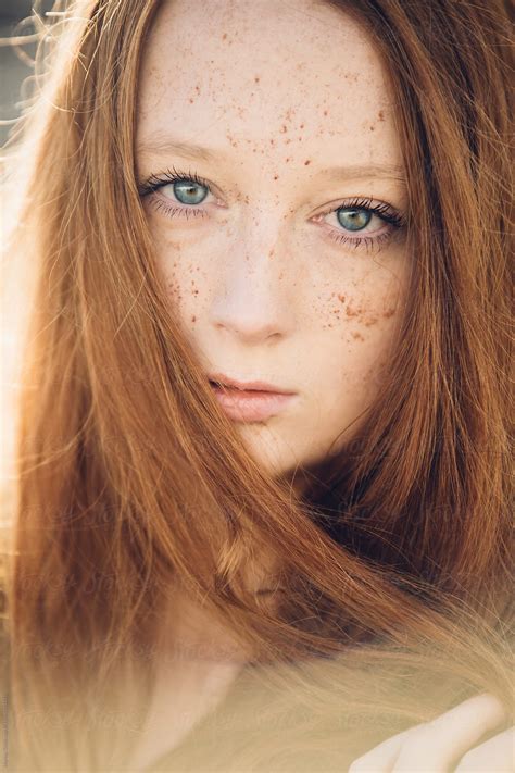 Portrait Of A Ginger Teenager In The Sunlight With Freckles And Long