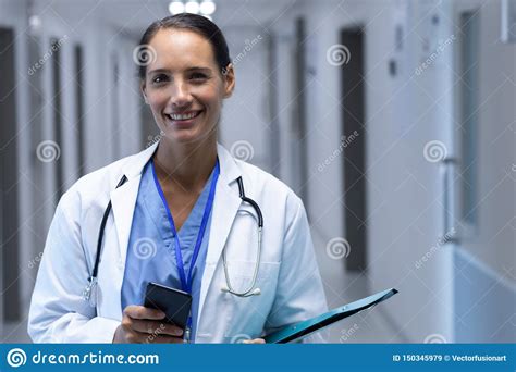 Female Doctor Looking At Camera In The Corridor At Hospital Stock Image