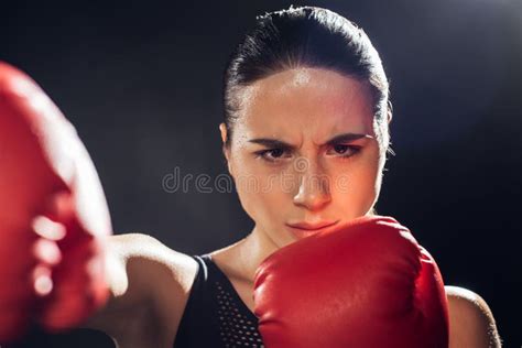 Serious Boxer In Boxing Gloves Training And Looking Away Stock Photo