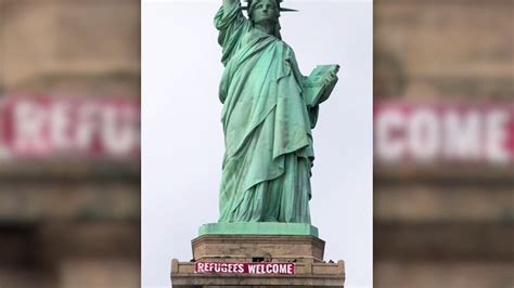 ‘refugees welcome banner unfurled across statue of liberty pix11