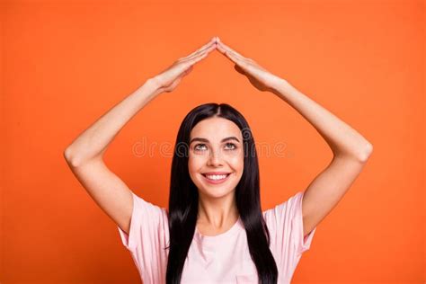 Portrait Of Positive Lady Look Up Arms Make House Figure Beaming Smile Isolated On Orange Color