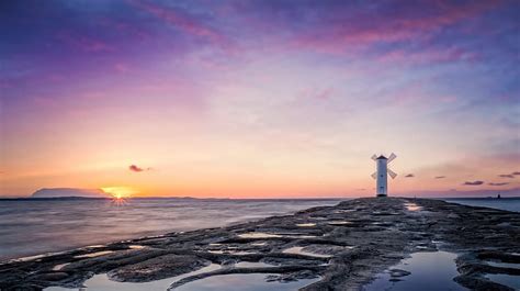 Lighthouse At Sunrise Lighthouses Sea Sky Oceans Sunrise Nature