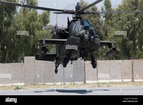 A Us Army Ah 64 Apache Helicopter Flies To A Forward Arming And