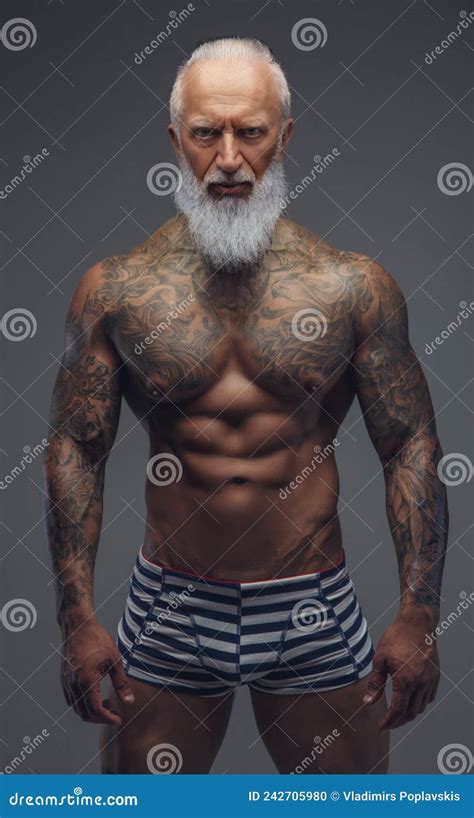 Naked Grandfather With Muscular Tattooed Body On Gray Stock Photo