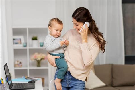 Mother With Baby Calling On Smartphone At Home Stock Photo Image Of