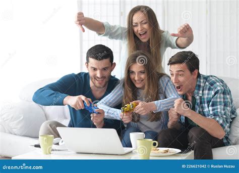 Portrait Of People Playing Computer Game With Laptop Stock Photo