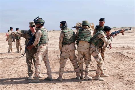 A Us Soldier Instructs Iraqi Army Soldiers During A Mounted Breach