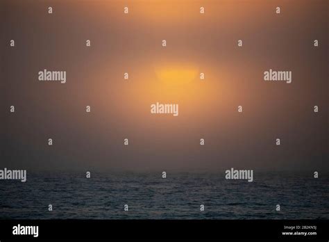 Cloudy Sunset Over The Ocean Stock Photo Alamy