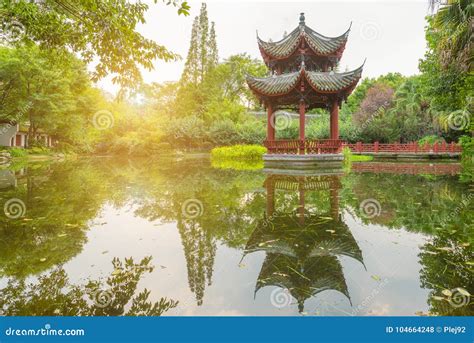 Chinese Pavilion Reflecting In A Pond In Baihuatan Public Park Stock