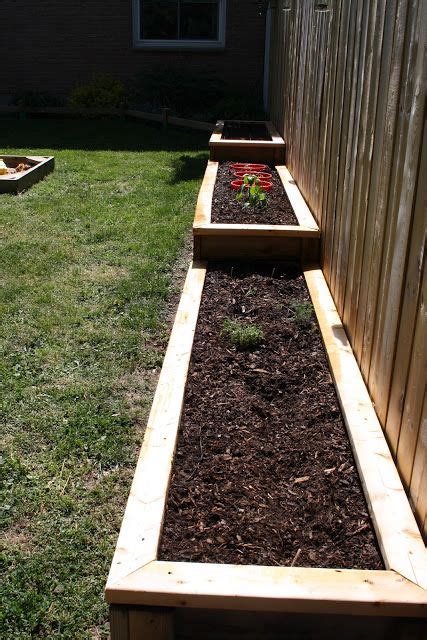 My husband and i have a very small backyard in an urban area, and we decided to build a raised garden bed along the fence using concrete pavers. 12 Raised Garden Bed Tutorials