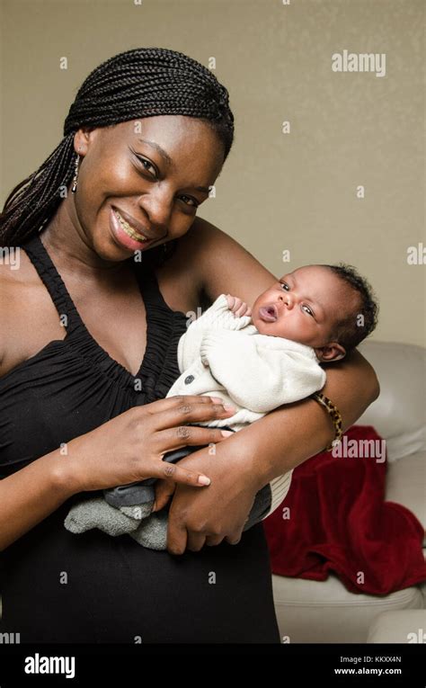 Attractive African American Mother Holding Newborn Baby Boy Stock Photo
