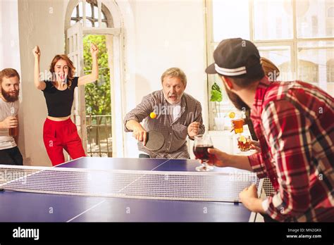 Group Of Happy Young Friends Playing Ping Pong Table Tennis Stock Photo