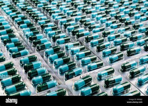 Closeup green-blue antibiotic capsule pills in blister pack