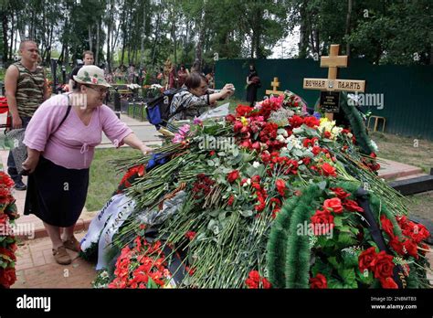 people lay flowers at the grave of former russian army colonel yuri budanov who was killed on