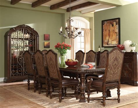 Sleek, dark wood dining table accompanied by eight chairs. Valencia Antique Style Trestle Formal Dining Set