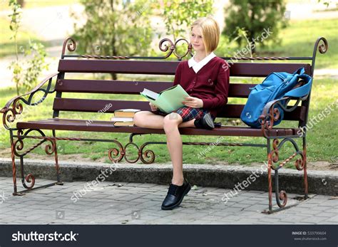 Schoolgirl Reading Book While Sitting On Stock Photo 533799604