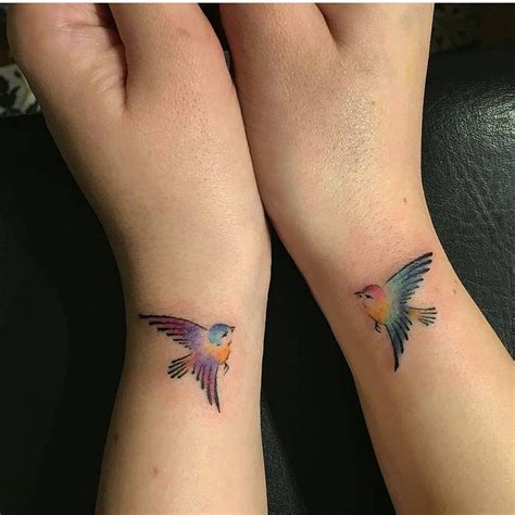 Little Bird Tattoo On Wrists With Contrasting Colors Tattoos For