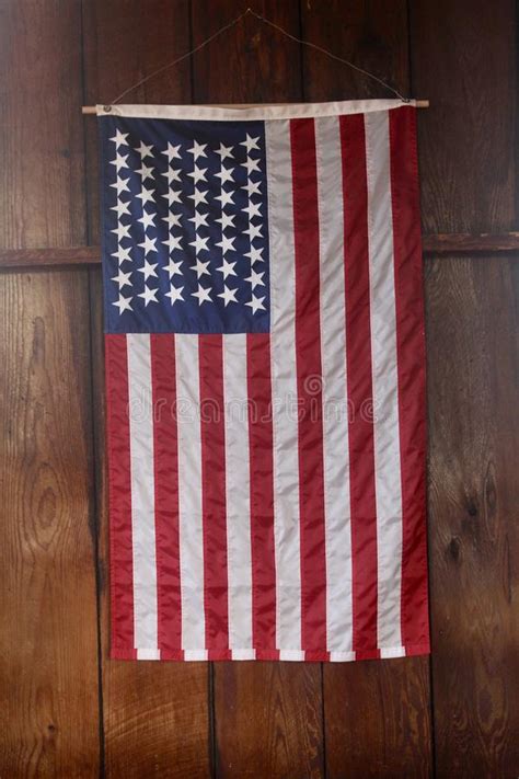 American Flag Close Up Hanging Vertically On Wood Wall Stock Image