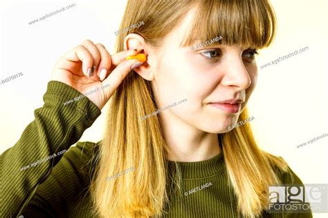 Woman Putting Ear Plugs Into Her Ears Getting Rid On Noise In Loud