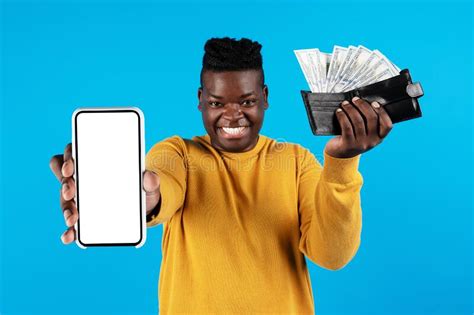 Cheerful Black Male Demonstrating Blank Smartphone And Wallet With