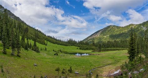 Green Grass Field And Trees Near Mountain Under Blue Sky · Free Stock Photo