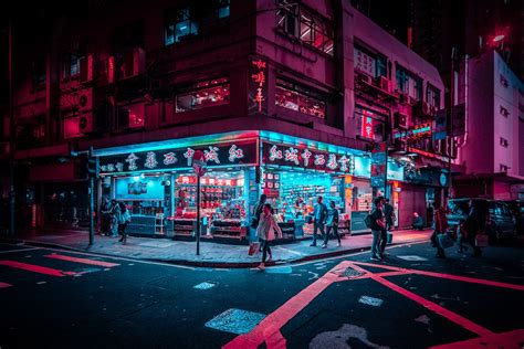 People Are Walking On The Street At Night In Front Of A Chinese