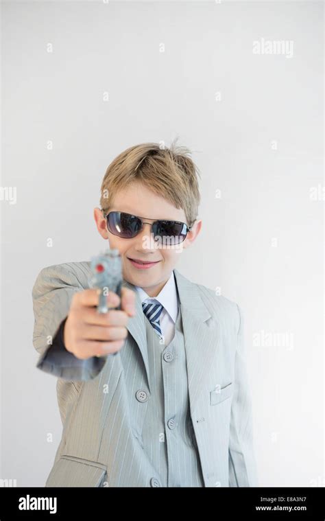 Boy Holding Toy Gun And Playing Gangster Smiling Stock Photo Alamy