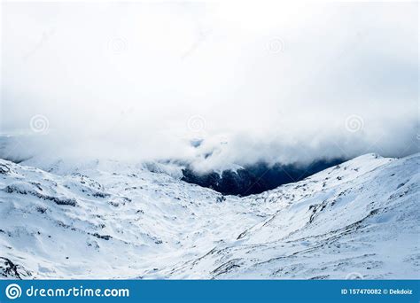 The Stunning Landscape Of The Snowy Mountain On A Foggy
