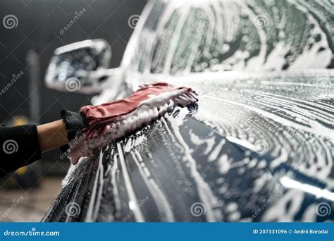 Car Detailing Worker Taking Care Of Vehicle Tires And Alloy Wheels Royalty Free Stock Image