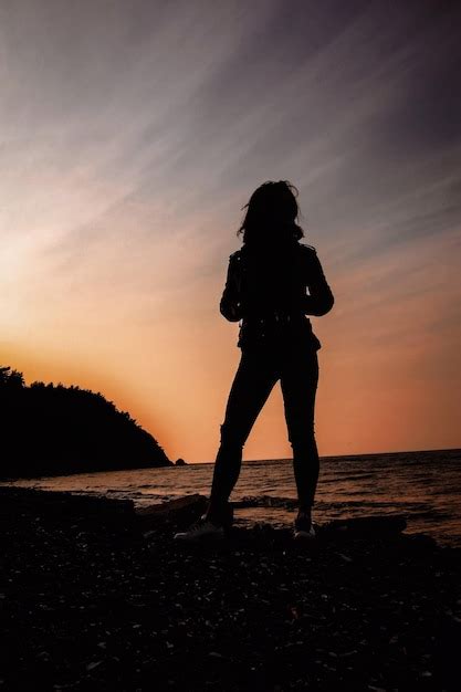 Premium Photo Silhouette Woman Standing At Beach During Sunset