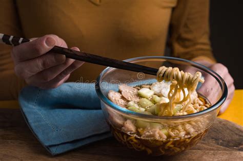 Woman Eating With Chopsticks Ramen Noodles With Chicken And Celery