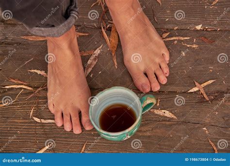 Women S Bare Feet Stand On A Wooden Floor Covered With Autumn Leaves Stock Photo Image Of