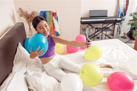 Cheerful Asian Woman Holding Balloon And Making Selfie Stock Image Image Of Camera Balloon