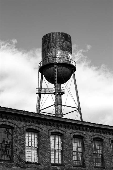 An Old Brick Building With A Water Tower On Top